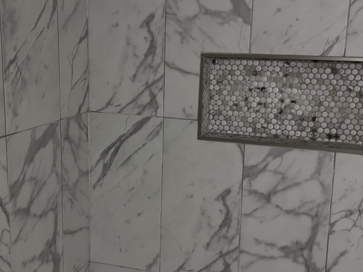 Custom marble shower tile with mosaic niche, bathroom remodel in Missoula